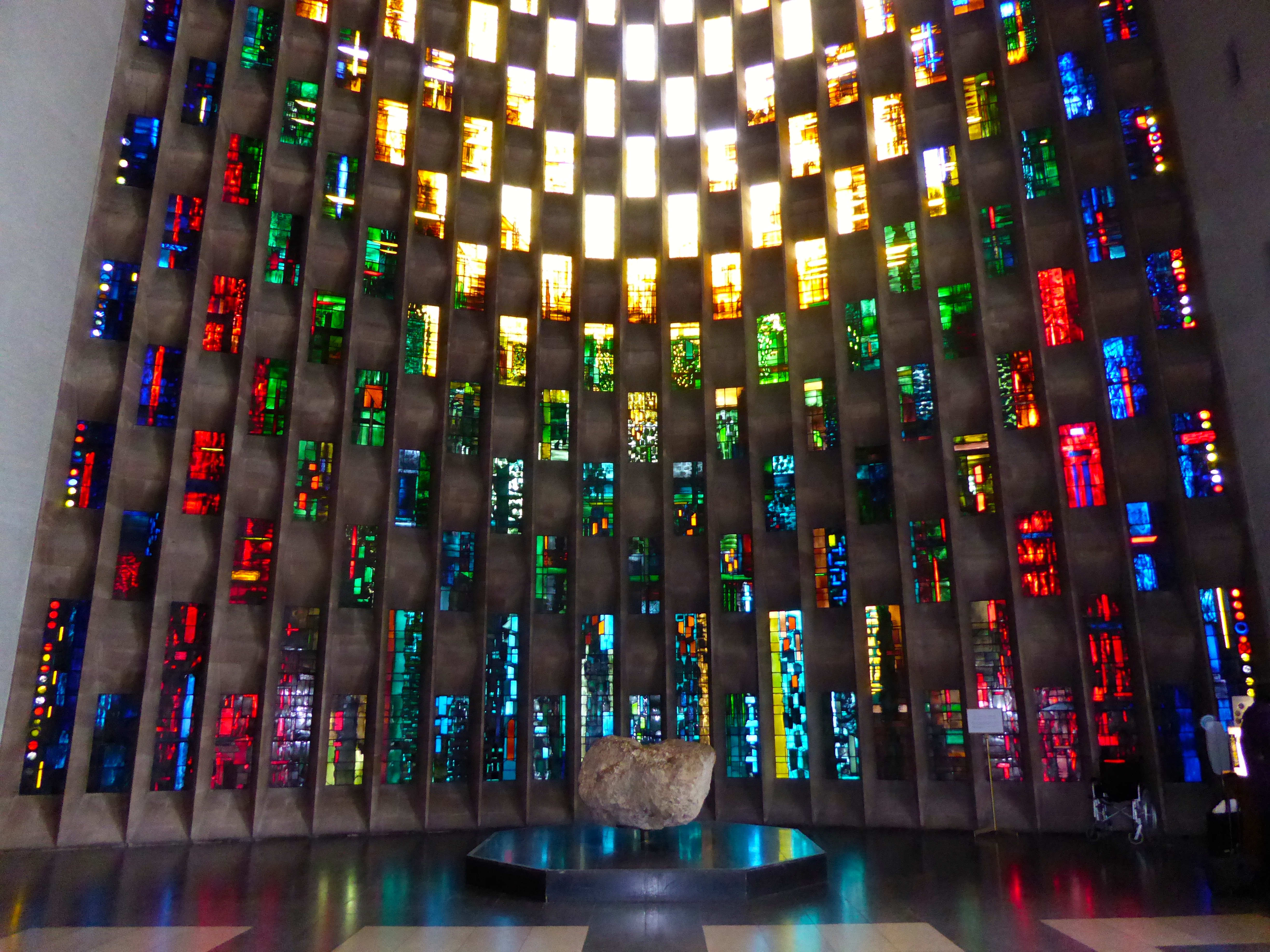 The bow window behind the baptismal font