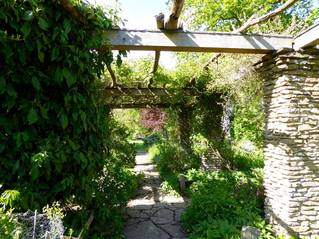 Pergola of Bargate stone by W.D. Caröe, the Arts and Crafts architect and grandfather of the present owners