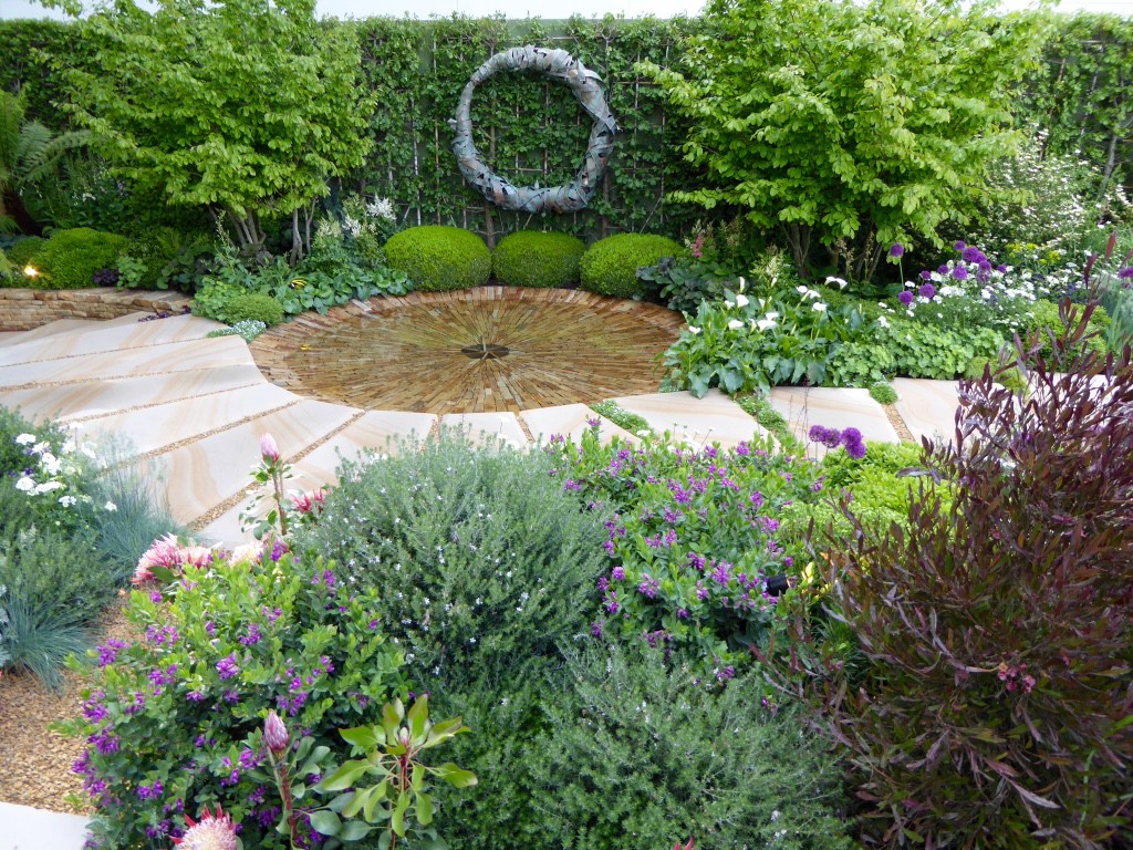 Charlie Albone has designed this garden as a space to tell his late father about his life since his passing.  The first section celebrates life with beautiful and romantic planting; the water feature in the next section reflects the emotions felt at the loss of someone close, as it can empty in a matter of seconds; and the rear of the garden is an intimate space to sit, connect and communicate with loved ones