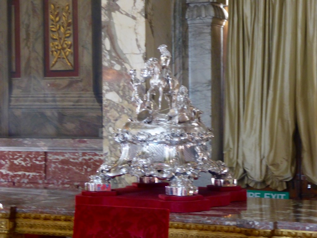 The silver epergne that Consuelo placed in the middle of the table to block out her despised husband